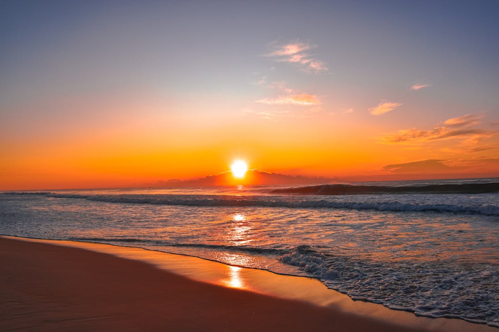 Mesmerizing sunrise view over a tranquil beach with gentle waves and golden colors with feeling of peace